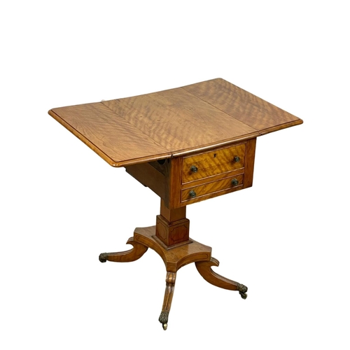 874 - A Regency Satin Birch pedestal drop leaf side table with 2 drawers and 2 dummy drawers, and on brass... 