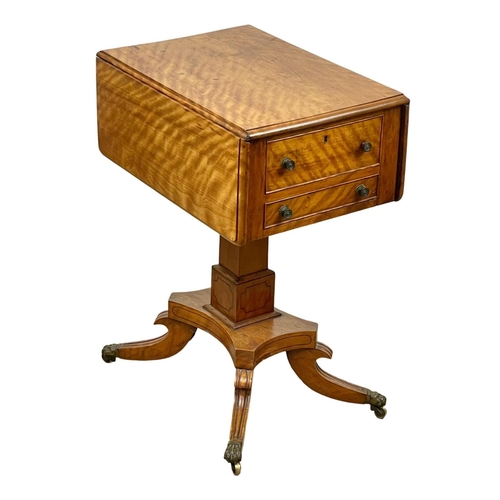 874 - A Regency Satin Birch pedestal drop leaf side table with 2 drawers and 2 dummy drawers, and on brass... 