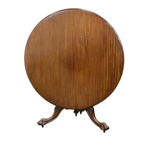 875 - A Victorian carved mahogany tilt top pedestal breakfast / dining table. Circa 1860. 120 x 74cm