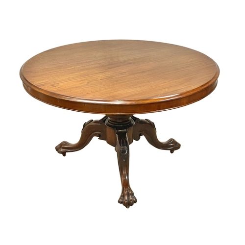 875 - A Victorian carved mahogany tilt top pedestal breakfast / dining table. Circa 1860. 120 x 74cm