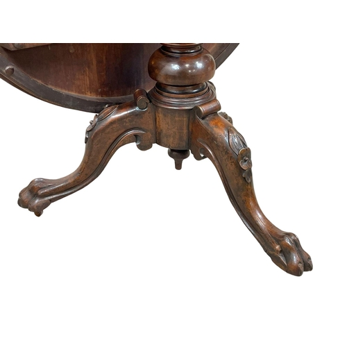 875 - A Victorian carved mahogany tilt top pedestal breakfast / dining table. Circa 1860. 120 x 74cm