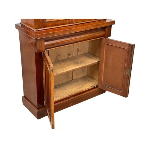 900 - A Victorian mahogany bookcase, with double glazed doors and drawer. 90 x 36.5 x 201cm