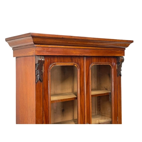 900 - A Victorian mahogany bookcase, with double glazed doors and drawer. 90 x 36.5 x 201cm