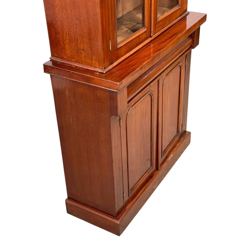 900 - A Victorian mahogany bookcase, with double glazed doors and drawer. 90 x 36.5 x 201cm