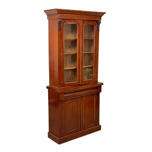 900 - A Victorian mahogany bookcase, with double glazed doors and drawer. 90 x 36.5 x 201cm