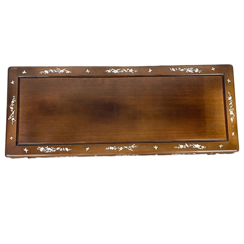 918 - A Chinese style coffee table with mother of pearl inlay. 124 x 50 x 42cm