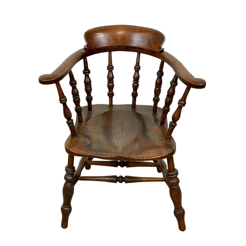 938 - A Victorian elm and beech armchair.