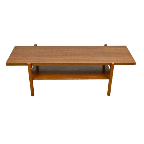 953 - A Mid Century teak 2 tier coffee table. 132 x 50 x 40cm