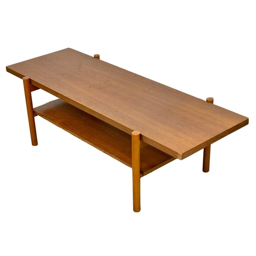 953 - A Mid Century teak 2 tier coffee table. 132 x 50 x 40cm