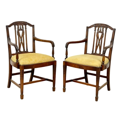 989 - A pair of Hepplewhite mahogany armchairs.