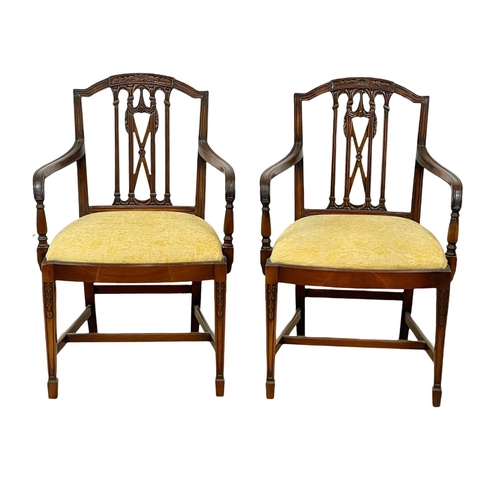 989 - A pair of Hepplewhite mahogany armchairs.