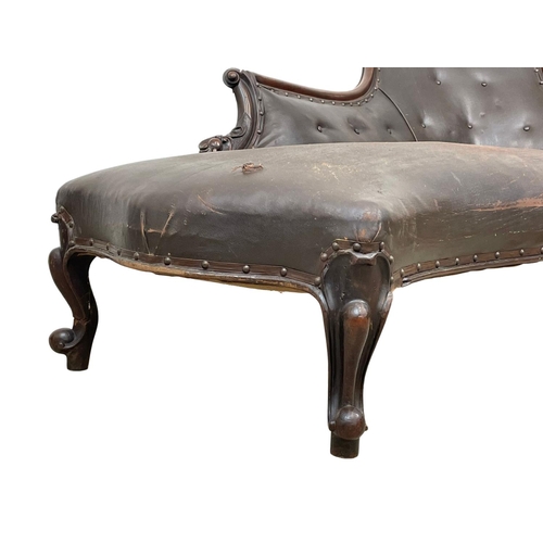 855 - A Victorian carved mahogany chaise lounge with early 20th century leather. 178cm