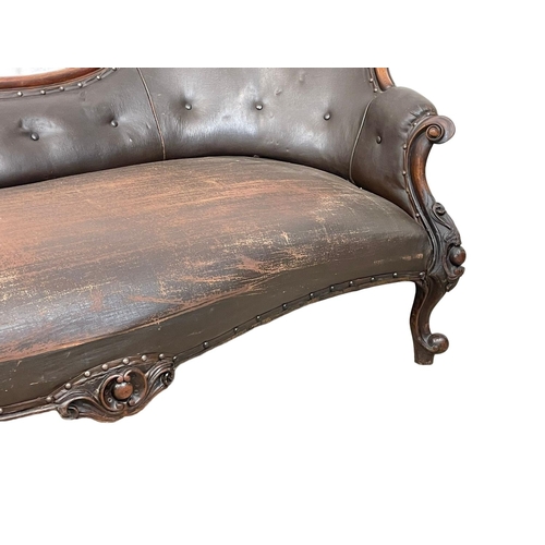 855 - A Victorian carved mahogany chaise lounge with early 20th century leather. 178cm