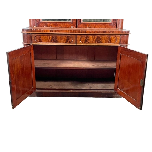 859 - A large Victorian mahogany bookcase, with mirrored doors and 2 drawers. 157 x 61 x 243cm