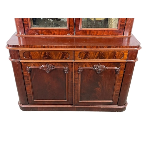 859 - A large Victorian mahogany bookcase, with mirrored doors and 2 drawers. 157 x 61 x 243cm