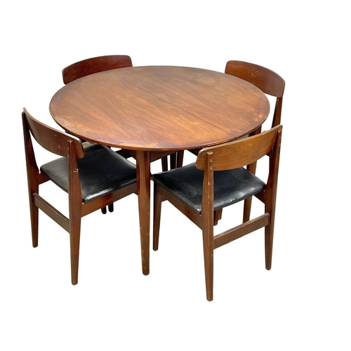 912 - A Mid Century teak table and 4 chairs. Open 146 x 108 x 73cm.