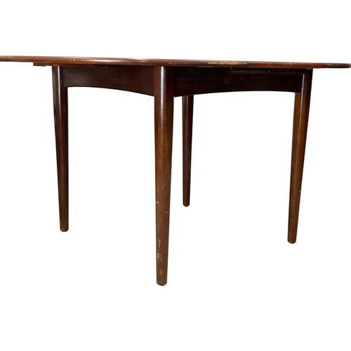 912 - A Mid Century teak table and 4 chairs. Open 146 x 108 x 73cm.