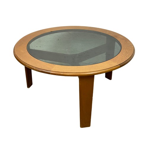 1064 - A Mid Century teak coffee table with smoked glass top. 87 x 43cm