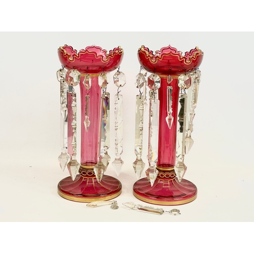 15 - A pair of large Victorian ruby glass lustres, with painted gilt rims. 17 x 36.5cm