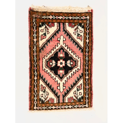 31 - A vintage Middle Eastern hand knotted prayer rug. 41 x 65cm