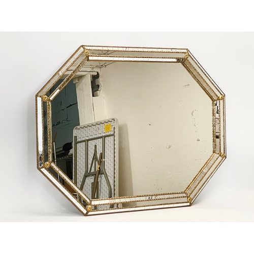 32 - A large ornate brass bound mirror. 100 x 75cm