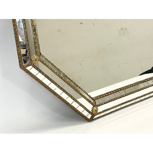 32 - A large ornate brass bound mirror. 100 x 75cm