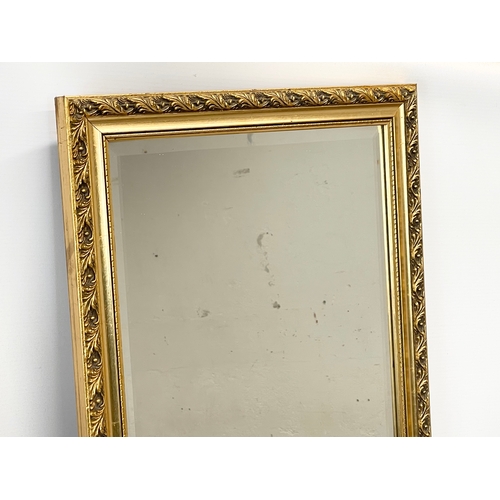 33 - A near pair of ornate gilt framed mirrors. 38 x 98cm
