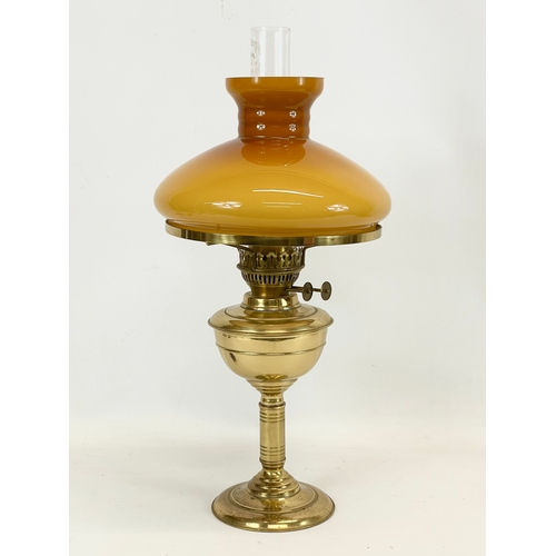 40 - A vintage brass double burner oil lamp with glass shade. 23 x 54cm