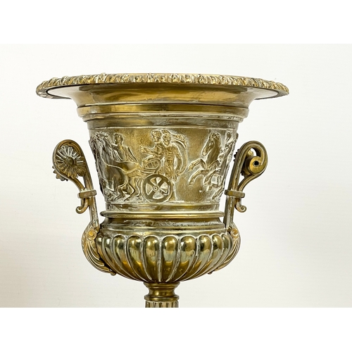 41 - A pair of large mid 19th century gilded brass garnitures on wooden bases. In the Neoclassical style.... 