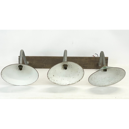 80 - A vintage industrial wall light. 76 x 59cm