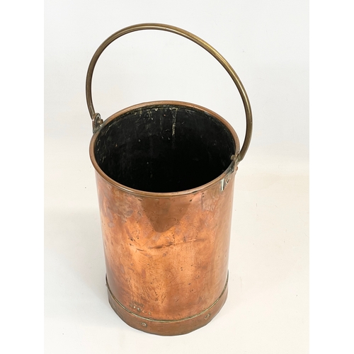 87 - A tall 19th century heavy copper bucket with brass handle. 26 x 56cm including handle.