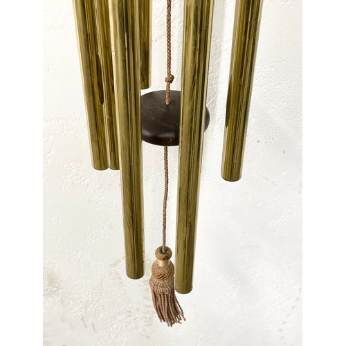 91 - A large early 20th century brass wall mounted wind chime. Circa 1900. 90cm