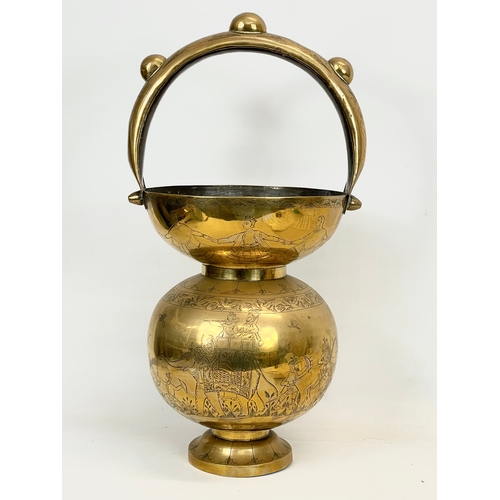 93 - An early 20th century Indian brass Kamandalu / Holy Water Carrier. Circa 1900. 29 x 56cm