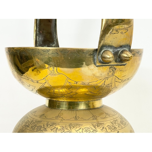 93 - An early 20th century Indian brass Kamandalu / Holy Water Carrier. Circa 1900. 29 x 56cm