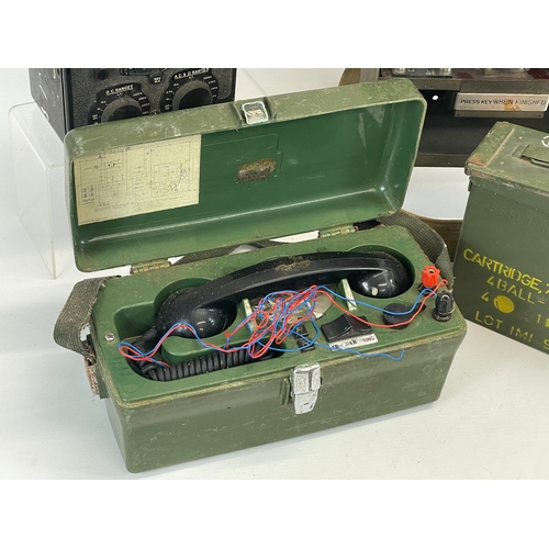 195 - A collection of military items. A military field telephone, an ammo box, a telephone set and morse c... 