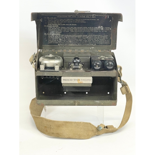 195 - A collection of military items. A military field telephone, an ammo box, a telephone set and morse c... 