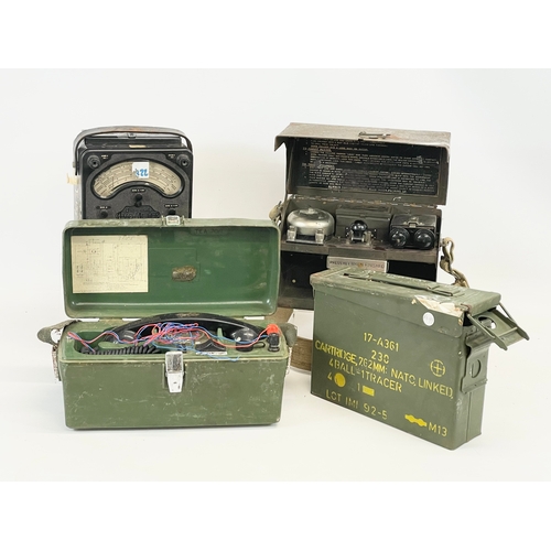 A collection of military items. A military field telephone, an