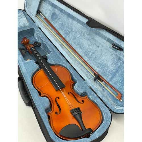 193D - A violin in case, by Rio. Case measures 77cm