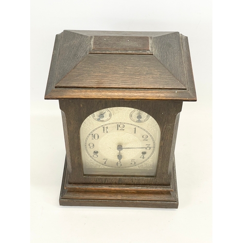 231 - A large late 19th century German oak mantle clock by Kienzle. With key and pendulum. 28 x 19 x 41cm