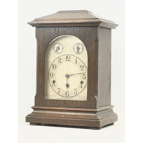 231 - A large late 19th century German oak mantle clock by Kienzle. With key and pendulum. 28 x 19 x 41cm