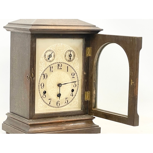 231 - A large late 19th century German oak mantle clock by Kienzle. With key and pendulum. 28 x 19 x 41cm