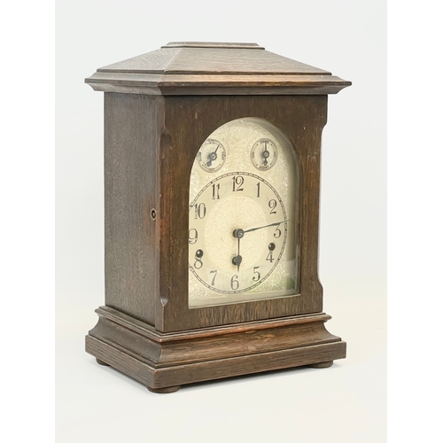 231 - A large late 19th century German oak mantle clock by Kienzle. With key and pendulum. 28 x 19 x 41cm