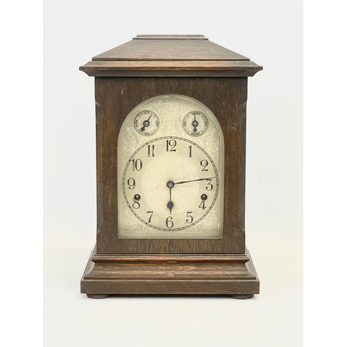 231 - A large late 19th century German oak mantle clock by Kienzle. With key and pendulum. 28 x 19 x 41cm