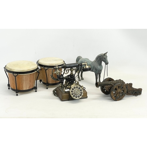 755 - A sundry lot. Including a large heavy brass horse, an old style telephone, a carved wooden and metal... 