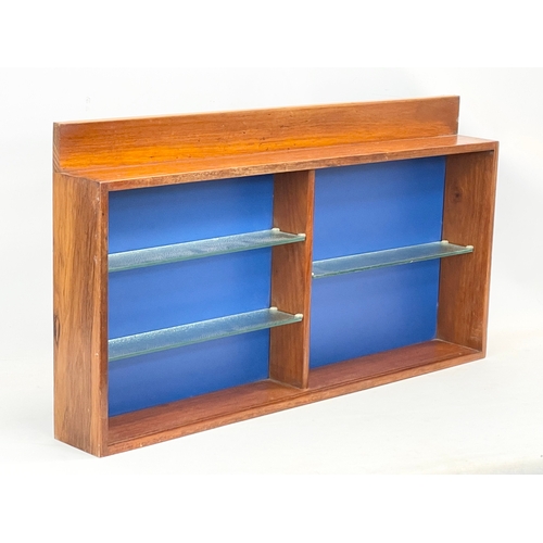 278 - A Mid Century wall mounted shelving unit with glass shelves. 92x12x49cm