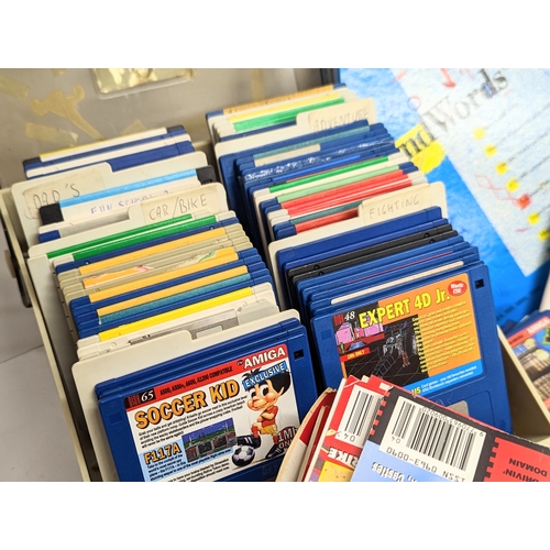 196I - A large quantity of Commodore Amiga games, Amiga floppy disks, Amiga magazines, etc.