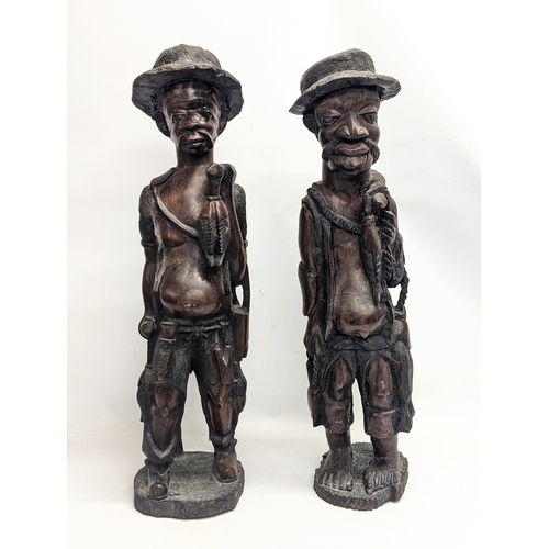 249 - A pair of large early 20th century carved padauk African figures. 72cm