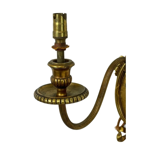 124 - A set of 4 early 20th century good quality ornate brass wall sconces. 26x35cm