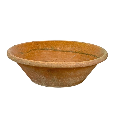 125 - A very large late 19th century French terracotta dough bowl. 71x22cm
