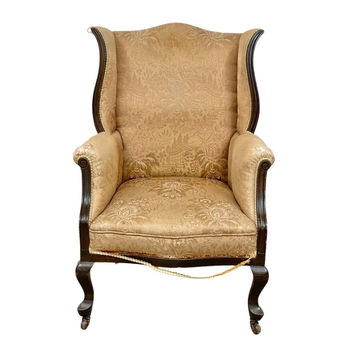 26 - An early 20th century mahogany framed wingback armchair. Circa 1920.